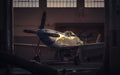 Vintage airplane inside a hangar with a warm glow